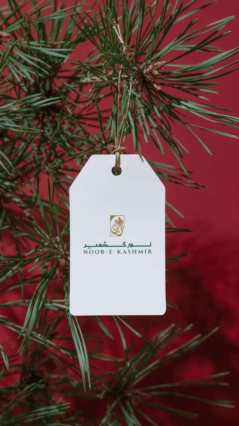 An ivory gift tag hanging among pine needles